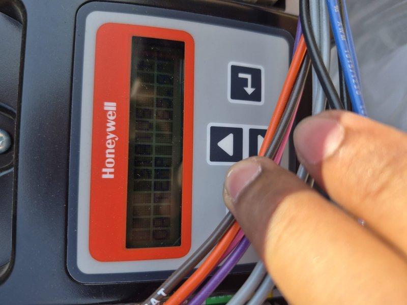 Responded to no cooling complaint in commercial building hallway. Inspected HVAC system and identified issue with Honeywell GT250A1001 control module. Evaluated thermostat operation, verified system settings, and documented control panel wiring configuration for diagnostic purposes.