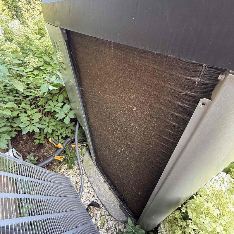 Responded to warranty call for recently installed AC unit experiencing humming noise from compressor during startup while maintaining cooling function. Upon inspection, found outdoor condenser coils heavily soiled with dirt, dust, and debris accumulation causing restricted airflow and increased compressor strain. Cleaned condenser coils thoroughly, removed debris buildup from fins, and verified proper system operation. Confirmed IAQ System Control Center functioning correctly with all UV lamp and ionizer modules operational as indicated by active status lights. Unit tested post-service with normal compressor operation, no abnormal humming noise detected, and proper cooling performance restored.
