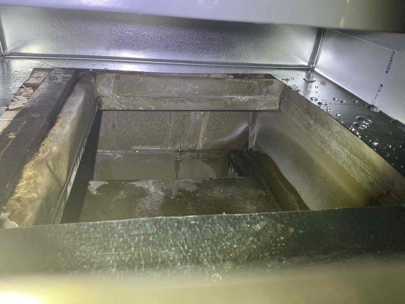 Completed evaporator coil replacement on commercial HVAC unit. Cut new access opening in existing ductwork and fabricated custom metal transition plenum to properly connect replacement coil to air distribution system. Removed deteriorated coil showing significant water damage, biological growth, and surface corrosion throughout interior compartment. Installed new coil assembly and secured with appropriate brackets and fasteners. Constructed transition box from sheet metal ductwork to accommodate dimensional differences between new equipment and existing infrastructure. Sealed all joints and connections to ensure proper airflow and system efficiency. Unit tested and operational upon completion.
