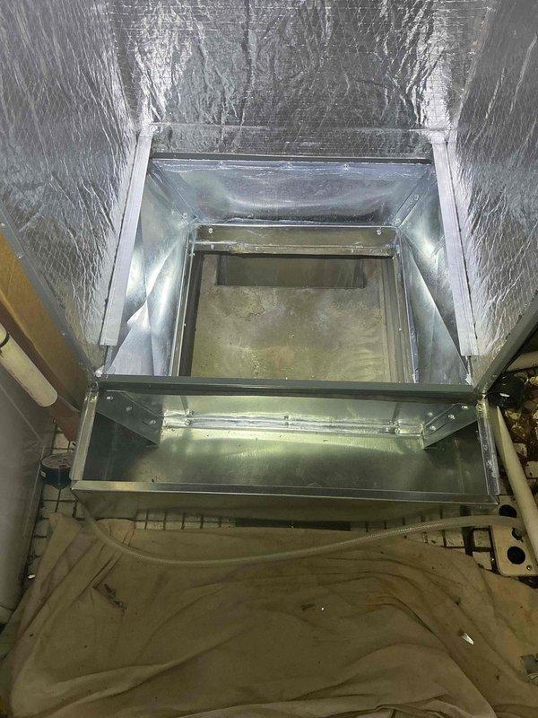 Completed evaporator coil replacement on commercial HVAC unit. Cut new access opening in existing ductwork and fabricated custom metal transition plenum to properly connect replacement coil to air distribution system. Removed deteriorated coil showing significant water damage, biological growth, and surface corrosion throughout interior compartment. Installed new coil assembly and secured with appropriate brackets and fasteners. Constructed transition box from sheet metal ductwork to accommodate dimensional differences between new equipment and existing infrastructure. Sealed all joints and connections to ensure proper airflow and system efficiency. Unit tested and operational upon completion.