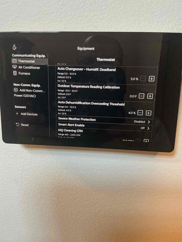 Responded to warranty callback for persistent high humidity readings on digital thermostat. Accessed thermostat settings menu and verified configuration parameters including Auto Dehumidification Overcooling Threshold set at 4.0%, Humidity Deadband at 5.0%, and confirmed communicating equipment connections. Replaced thermostat per previous technician recommendation after software update did not resolve ongoing humidity control issue.