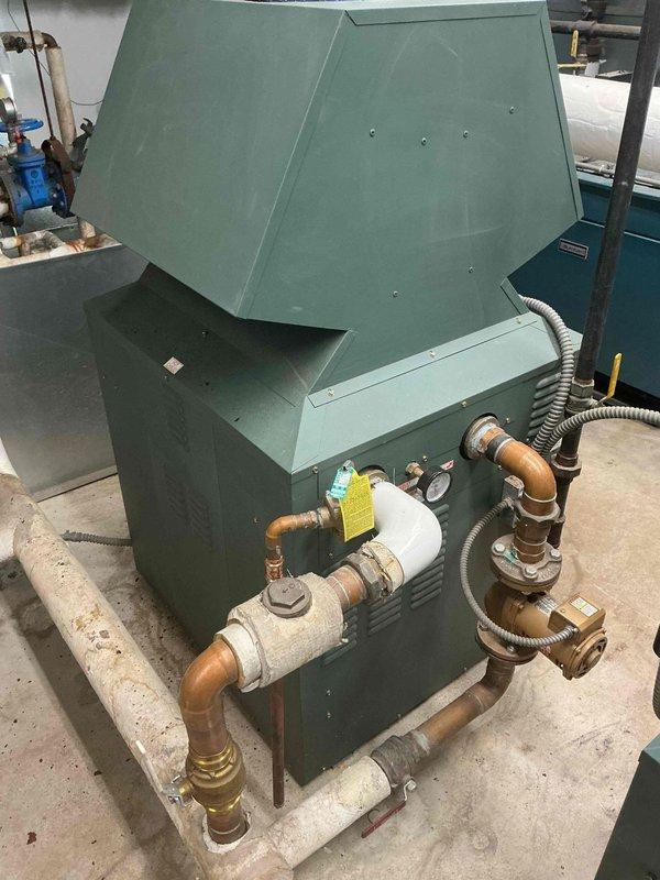 Responded to inspection concern regarding pressure relief valve installation on domestic hot water system versus heating boiler. Documented and photographed both the DHW pressure relief valve assembly with copper piping connections and the complete heating boiler unit to verify proper valve placement and specifications for inspector review and approval.