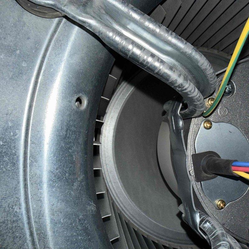 Responded to new customer no-cooling complaint and performed diagnostic evaluation of residential split system air conditioning unit. Inspected outdoor condenser unit and indoor air handler blower assembly, connected gauges to service ports to assess refrigerant pressures and system performance. Documented equipment information and captured photos of both indoor blower motor assembly with ductwork connections and outdoor condensing unit for service records.