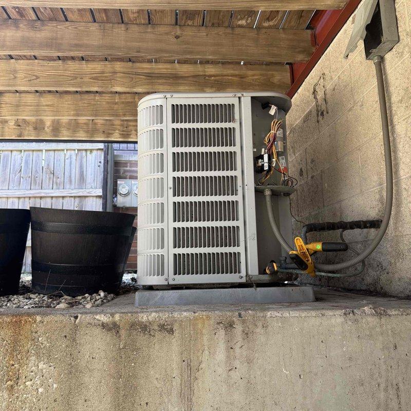 Responded to new customer no-cooling complaint and performed diagnostic evaluation of residential split system air conditioning unit. Inspected outdoor condenser unit and indoor air handler blower assembly, connected gauges to service ports to assess refrigerant pressures and system performance. Documented equipment information and captured photos of both indoor blower motor assembly with ductwork connections and outdoor condensing unit for service records.