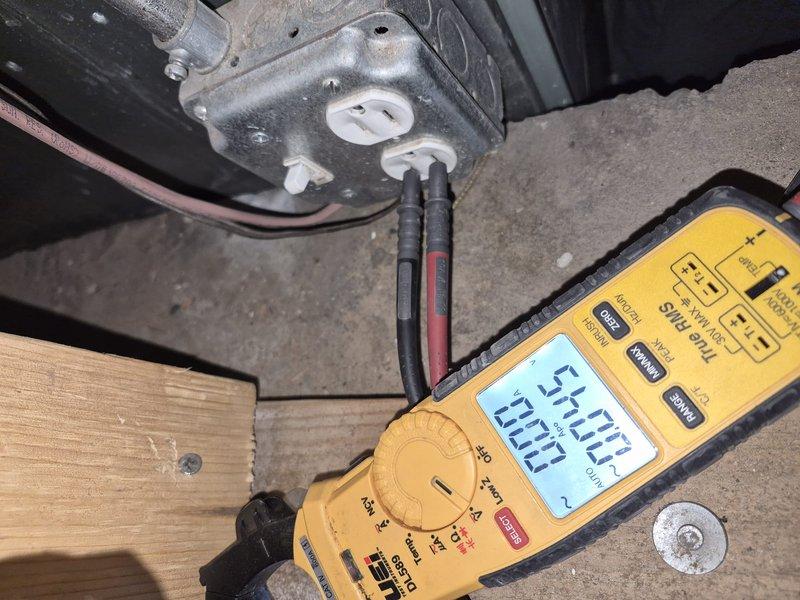 Responded to no cooling complaint with multiple thermostats displaying blank screens. Investigated rooftop HVAC units and performed voltage testing at equipment location, measuring electrical readings to diagnose communication and power supply issues. Documented rooftop condenser units and electrical connections for further assessment of thermostat communication failure.