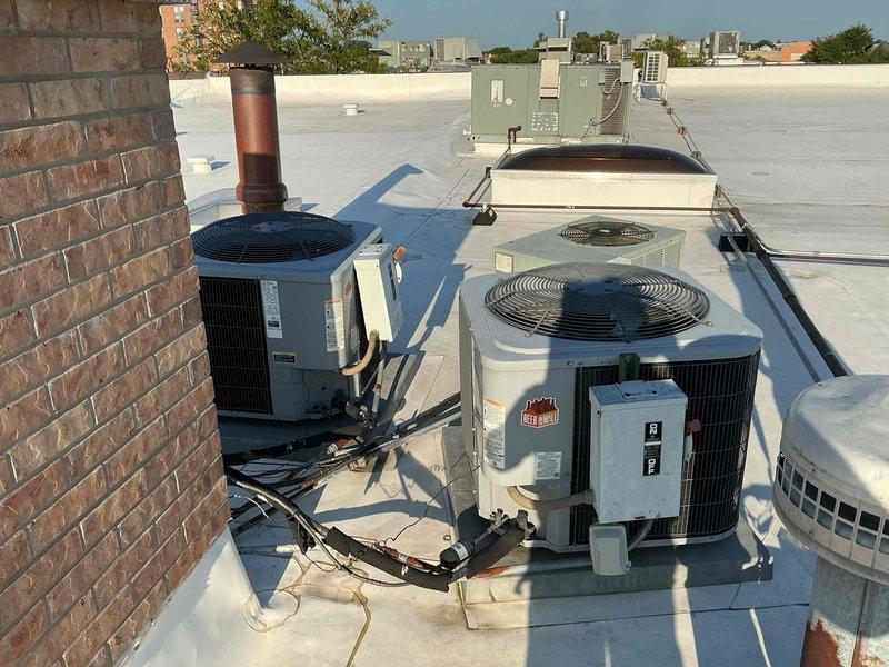 Responded to no cooling complaint with multiple thermostats displaying blank screens. Investigated rooftop HVAC units and performed voltage testing at equipment location, measuring electrical readings to diagnose communication and power supply issues. Documented rooftop condenser units and electrical connections for further assessment of thermostat communication failure.