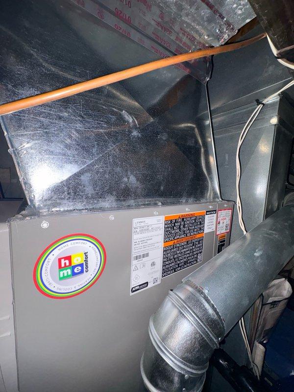 Returned to site to address ongoing air leakage concerns on recently installed Lennox HVAC system. Conducted thorough inspection of furnace, air handler, and ductwork connections in basement mechanical room and attic space. Documented current installation condition with photos showing wall-mounted equipment, furnace unit with ductwork connections, copper piping, and attic-mounted HVAC components with ENERGY STAR certification. Discussed installation concerns with family member present who has industry experience with Lennox products. Customer remains concerned about air leakage issues and overall installation quality requiring further evaluation and remediation.