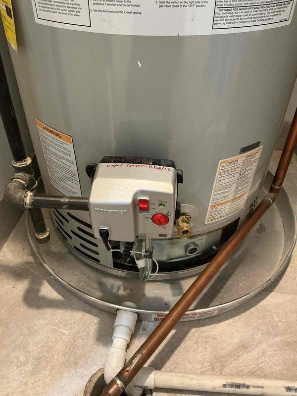 Completed vapor system replacement on residential tanked water heater. Ordered and installed replacement parts from Ferguson supply house. Verified proper gas combustion with clean blue flame at burner assembly. Inspected gas control valve, thermostat operation, and all pipe connections including copper supply lines and PVC drainage system. Confirmed unit is operating safely with all safety labels intact and control functions responding appropriately.