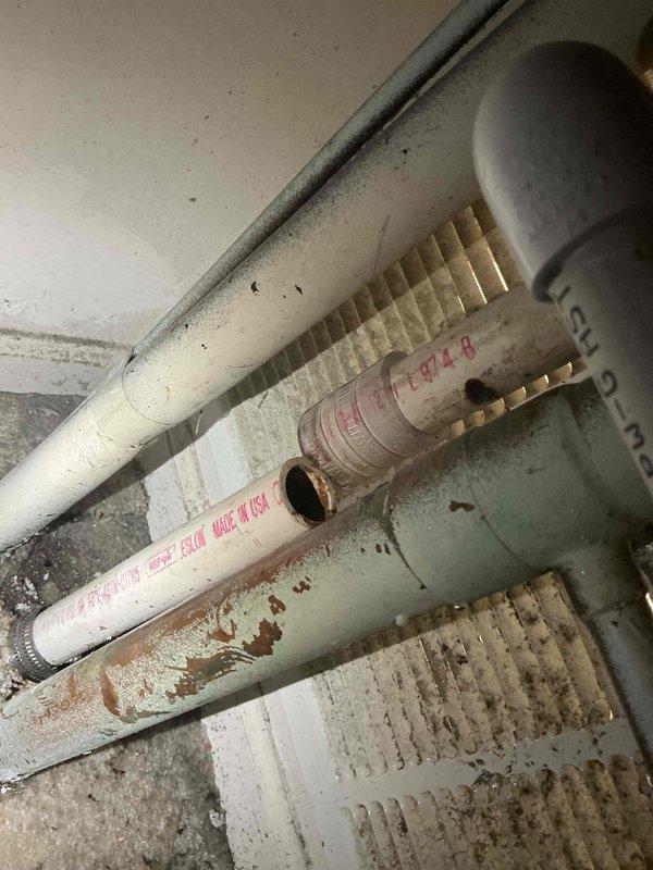 Responded to commercial A/C service call for clogged condensate drain line issue. Upon inspection, identified blockage in drain piping system causing water backup. Documented existing conditions with photos showing deteriorated insulation on refrigerant lines and compromised drain assembly with visible water damage and staining. Contacted office to coordinate approval process with property management prior to proceeding with drain line clearing and repairs.