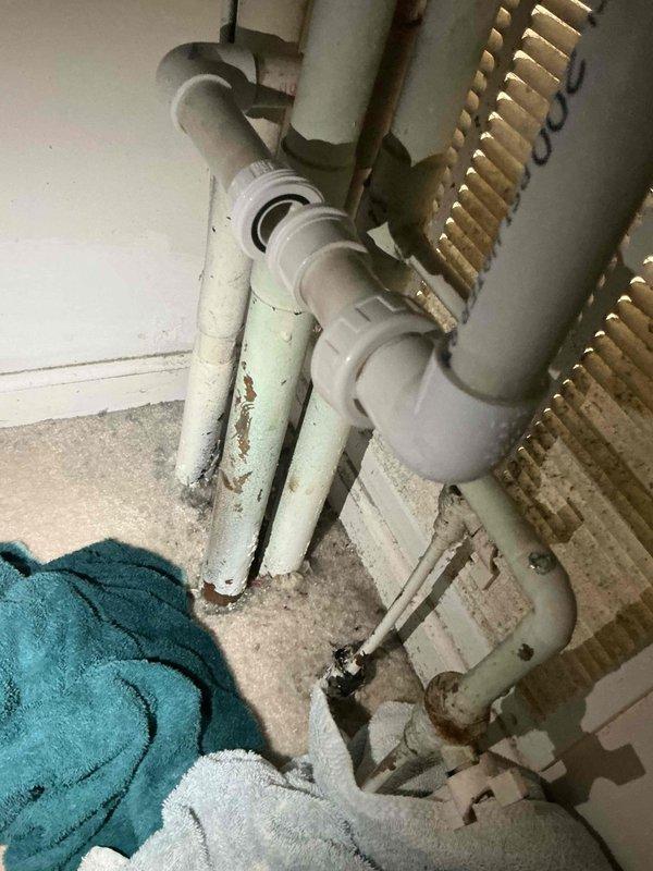 Responded to commercial A/C service call for clogged condensate drain line issue. Upon inspection, identified blockage in drain piping system causing water backup. Documented existing conditions with photos showing deteriorated insulation on refrigerant lines and compromised drain assembly with visible water damage and staining. Contacted office to coordinate approval process with property management prior to proceeding with drain line clearing and repairs.