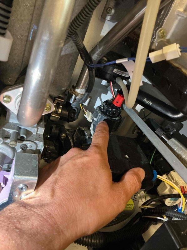Responded to service call for 15-year-old Navien NPE-2024 tankless water heater experiencing water leak from tank assembly with approximately 2.5 gallons daily loss. Upon inspection, identified leak source and accessed internal components to diagnose issue. Performed hands-on troubleshooting of electrical connections, wiring harnesses, and mechanical assemblies within the unit. Inspected and tested all wire connections including blue, yellow, and white wire harnesses, verified proper seating of connectors, and examined mounting brackets and tube connections for integrity. Successfully resolved leak issue and restored unit to proper operating condition.