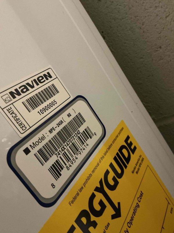 Responded to service call for 15-year-old Navien NPE-2024 tankless water heater experiencing water leak from tank assembly with approximately 2.5 gallons daily loss. Upon inspection, identified leak source and accessed internal components to diagnose issue. Performed hands-on troubleshooting of electrical connections, wiring harnesses, and mechanical assemblies within the unit. Inspected and tested all wire connections including blue, yellow, and white wire harnesses, verified proper seating of connectors, and examined mounting brackets and tube connections for integrity. Successfully resolved leak issue and restored unit to proper operating condition.