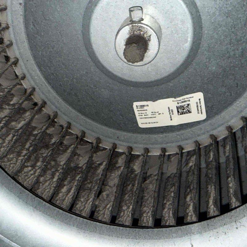 Performed annual clean and check maintenance on air conditioning system at rectory location per comfort plan agreement. Inspected and photographed blower wheel assembly, noting moderate dust accumulation on squirrel cage blades and housing. Verified temperature readings using calibrated digital thermometer and documented equipment information for service records.