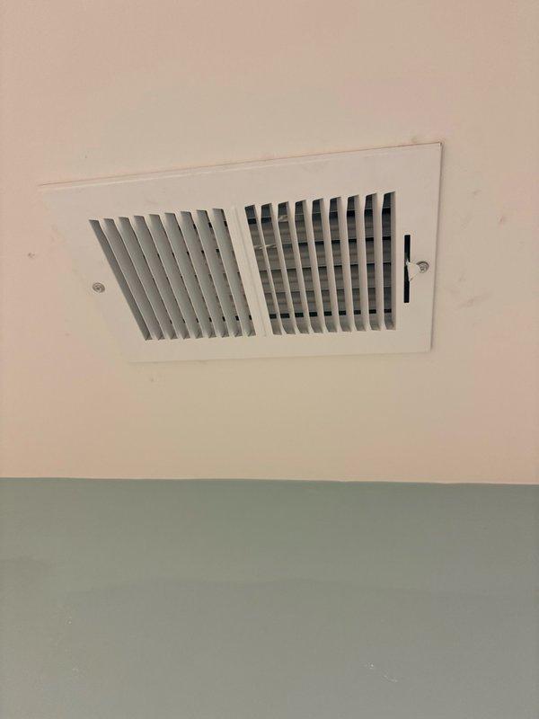 Completed installation of two white rectangular ceiling-mounted supply registers in commercial space. Both units were properly secured with mounting screws and feature adjustable horizontal slats for airflow control. Installation was coordinated during customer's available window between 2-5pm using parts previously staged at office.