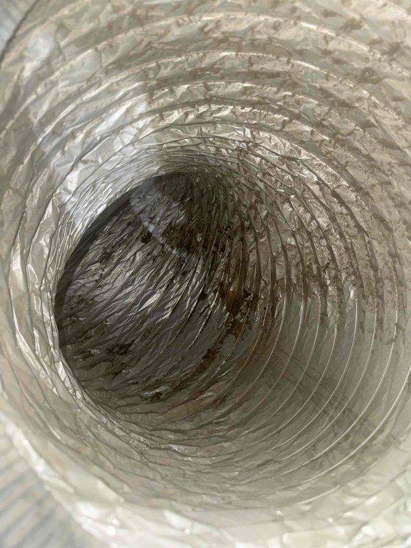 Responded to service call for water leak at air handler. Upon arrival, confirmed rusted condensate drain pan beneath furnace with active condensation leakage, initially discovered by plumber during drain line service. Inspected HVAC system and photographed oxidized copper refrigerant lines, ductwork connections, and drainage components. Documented heavily soiled flexible ductwork with significant dust and debris accumulation. Assessed air handler installation showing age-related deterioration of drain pan and surrounding mechanical components. Provided customer with diagnostic findings regarding failed condensate pan requiring replacement to prevent continued water damage. Discussed repair options and presented recommendations for drain pan replacement and system maintenance.