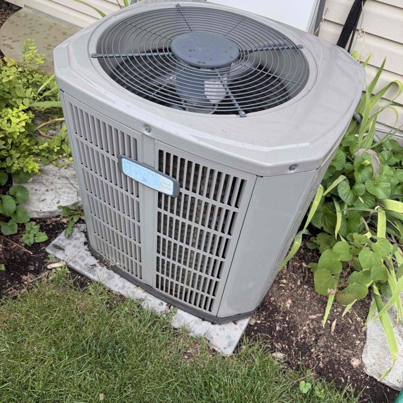 Responded to customer concern regarding lights dimming when air conditioning system operates. Performed diagnostic evaluation of outdoor condensing unit, measuring electrical draw with clamp meter which showed reading of 385.1 amps, indicating abnormally high amperage draw on startup. Inspected internal electrical components including capacitor, contactor, and wiring connections for potential issues causing excessive current demand that would affect household electrical system.