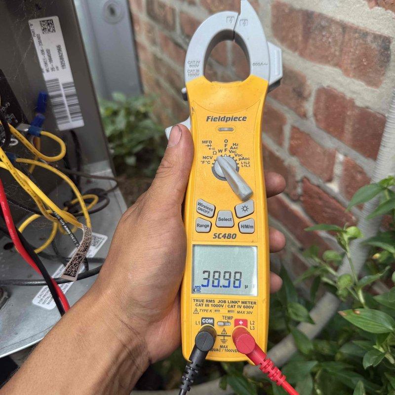 Responded to follow-up warranty call for rattling noise and flickering lights during system startup. Upon inspection, verified thermostat wiring configuration at Nest unit, confirming absence of proper C-wire and G-wire connections as noted during previous service visit. Measured compressor amperage at 38.98 amps using clamp meter to verify normal operating parameters. Inspected time-delay relay previously installed at condenser unit and confirmed proper operation. Verified all thermostat terminal connections at Y, C, and W positions. System tested through multiple cooling cycles with no abnormal sounds or electrical issues observed. All components operating within normal specifications at time of departure.