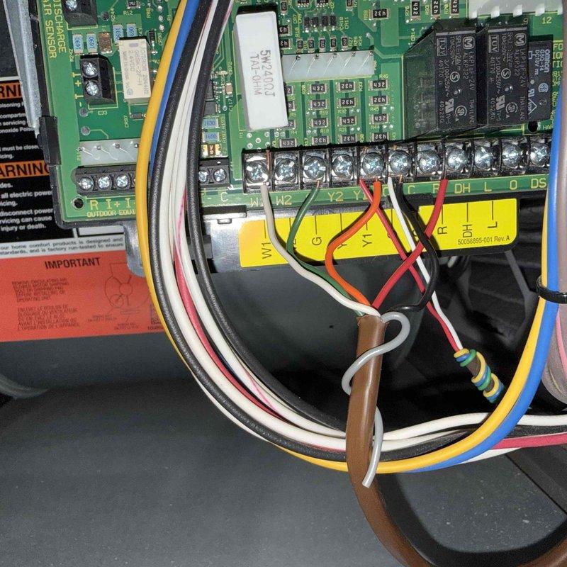 Responded to no cooling complaint on second floor unit. Upon arrival, confirmed system was not operating despite customer attempting to reset breaker. Performed diagnostic inspection of Bryant outdoor unit and examined control board assembly. Inspected circuit board components including relays, capacitors, and terminal connections. Verified wiring integrity at terminal block connections for compressor, fan, and control circuits. Documented equipment information and control board configuration with photos for service records.
