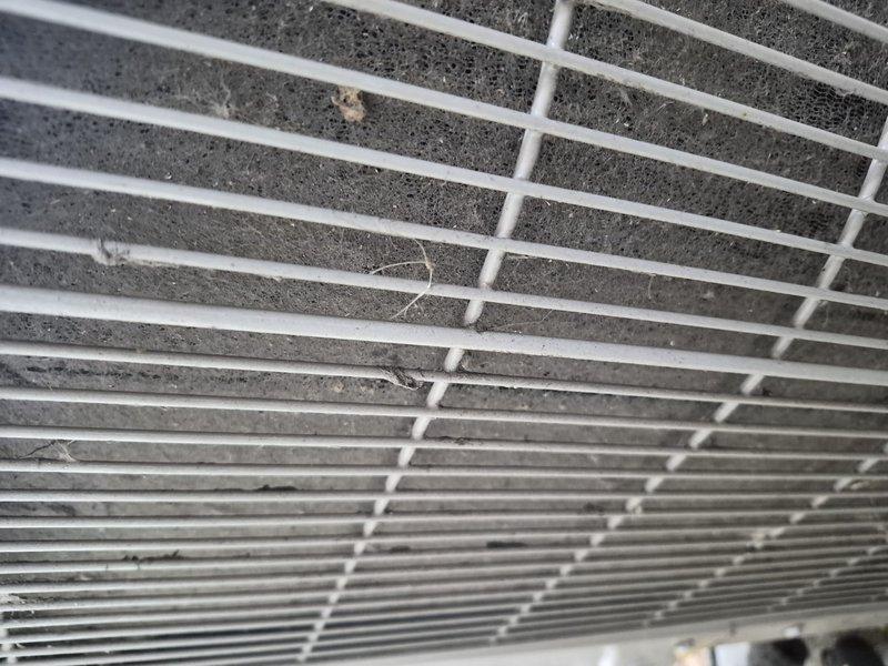 Responded to no cooling complaint on Unico system blowing warm air. Upon inspection, found return air filter heavily clogged with dust and debris, severely restricting airflow to the unit. Removed and replaced dirty filter with new filter, restoring proper system airflow and cooling operation.