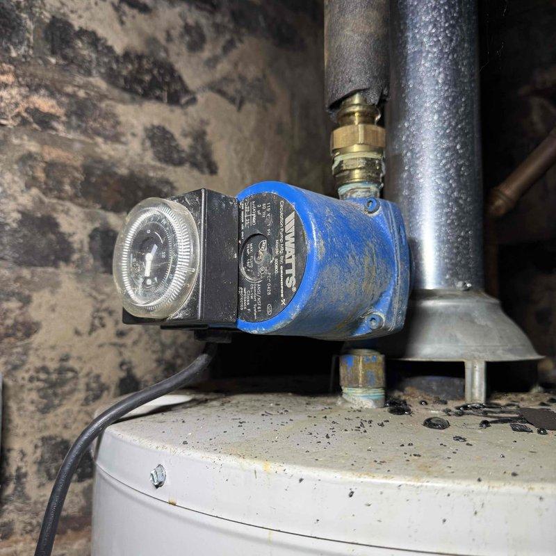 Responded to report of inefficient commercial water heater producing lukewarm water after short periods of use. Upon inspection, identified failed circulator pump with malfunctioning timer control affecting heat distribution throughout the system. Replaced defective circulator pump assembly and timer mechanism, tested unit operation to verify proper water temperature maintenance and adequate hot water recovery time.