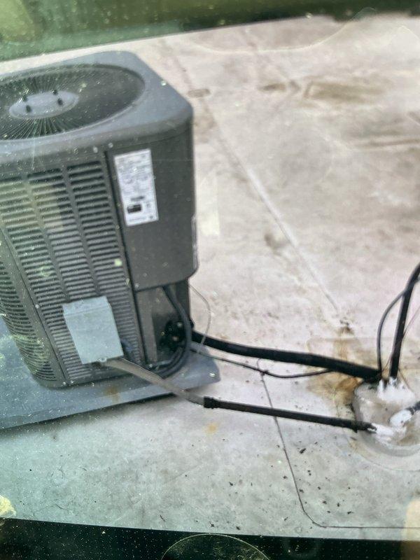Responded to refrigerant leak on front office air conditioning system. Located active leak on outdoor lineset where low-side copper tubing emerges from building roof. Cut out damaged section of copper lineset and replaced with new piping. Performed nitrogen pressure test to verify system integrity and checked high-side line for potential leaks during repair process. Evacuated system and recharged with proper refrigerant. Adjusted TXV sensing bulb positioning and verified system pressures stabilized to acceptable operating range with low side settling in low 150 PSI range. System tested and confirmed operational upon completion.