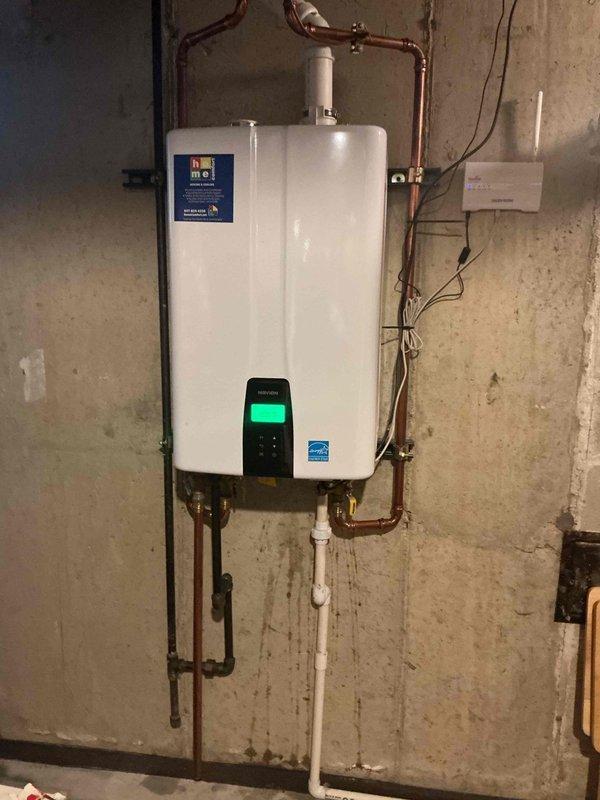 Completed tankless water heater flush service on wall-mounted unit. Removed and cleaned inlet screen filter to remove sediment buildup and restore proper water flow. Unit operational with digital display functioning normally, all connections secure, and no leaks detected upon completion.