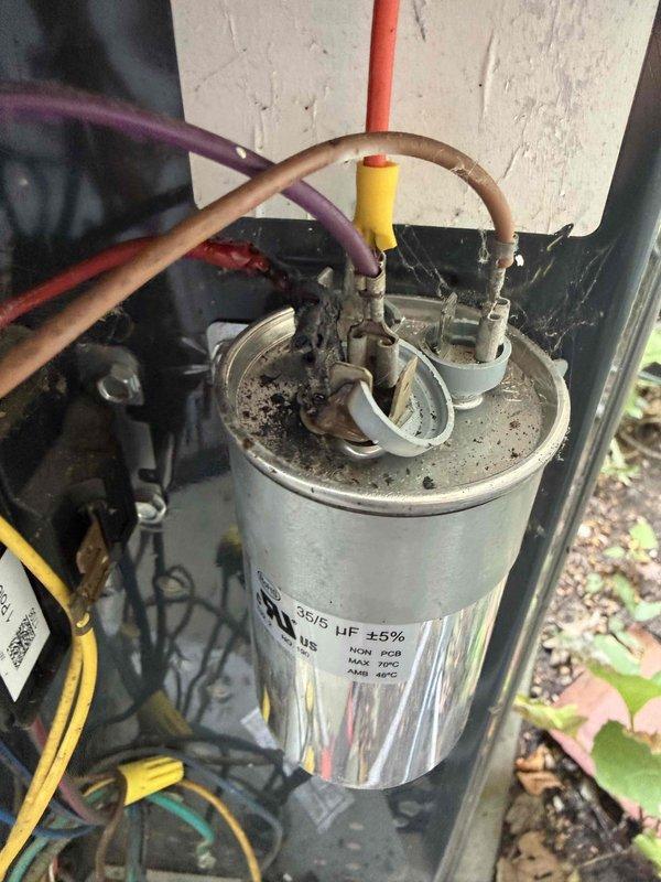 Responded to service call for upstairs air conditioning unit blowing warm air instead of cold. Upon inspection, diagnosed failed dual-run capacitor (370/5 μF) with visible corrosion and deterioration at terminal connections. Replaced defective capacitor with new unit matching system specifications. Verified all electrical connections secure and tested system operation. Unit now cooling properly with normal temperature differential across evaporator coil. Photographed electrical compartment and capacitor assembly for service records. Discussed proper system maintenance and preventative care recommendations with customer.