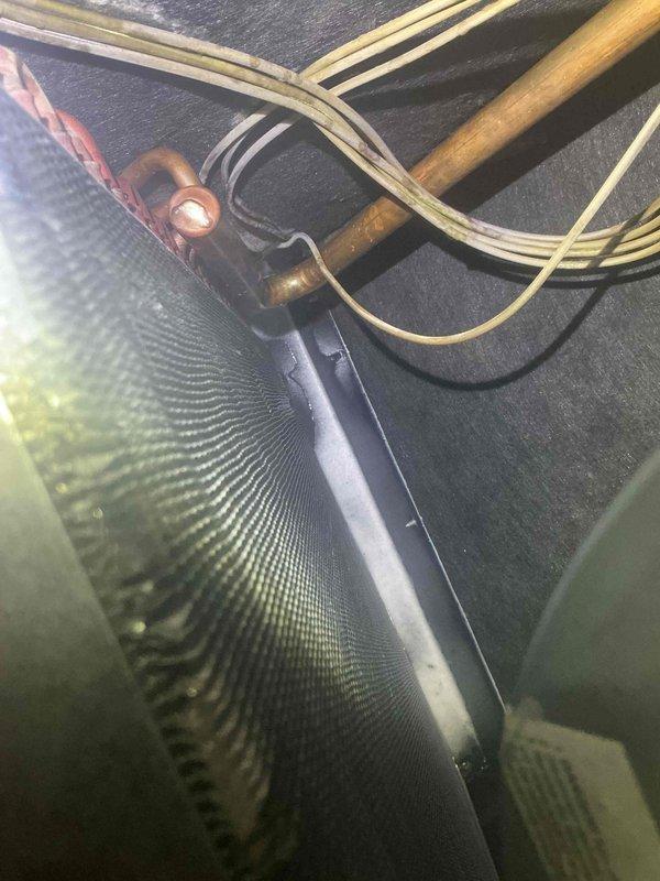 Responded to warranty callback for recurring leak at filter area of air handler unit. Inspected filter housing, evaporator coil section, and drain pan assembly. Documented existing conditions with photos showing internal components and coil assembly. No charge service completed per office authorization.
