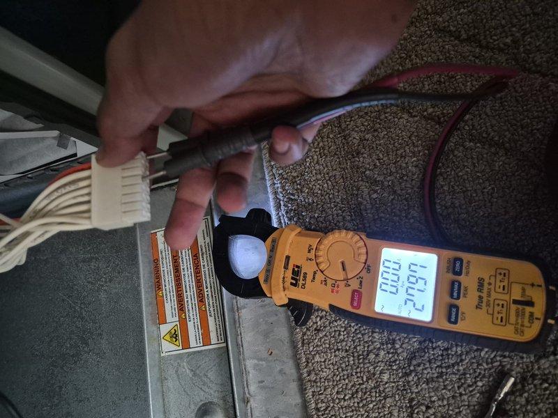Responded to no cooling call on approximately 2-year-old Trane system. Upon arrival, found thermostat calling for cooling with setpoint at 70°F while indoor temperature read 77°F. Performed diagnostic testing at indoor unit using clamp meter to check electrical amperage draw and system operation. Verified thermostat display showing permanent hold with system in cooling mode. Documented equipment information and captured diagnostic readings for service records.
