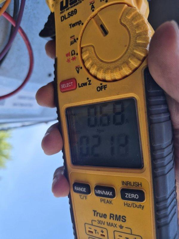 Responded to no cooling call on rooftop unit. Upon arrival, performed diagnostic testing using digital multimeter to check electrical components and system voltages. Inspected evaporator coil assembly and identified visible damage to coil casing with rust and corrosion present at bottom corner panel. Documented equipment condition with photos showing coil fin assembly and compromised metal housing. Discussed findings and repair options with customer.