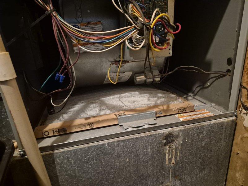 Responded to no cooling complaint for suite 1503 in multi-tenant office space. Upon inspection, discovered air filter had become dislodged from its proper position within the air handler unit, restricting airflow to the blower assembly. Repositioned air filter correctly in the filter track and verified secure placement. Tested system operation and confirmed unit returned to normal cooling function with proper airflow restored.