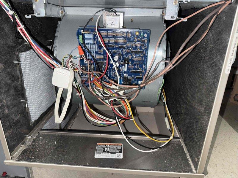 Replaced defective capacitor on HVAC system. Removed access panel to air handler unit, disconnected failed capacitor from control board, and installed new replacement capacitor with proper electrical connections. Verified all wire terminations were secure, tested system operation, and confirmed unit returned to normal cooling function.