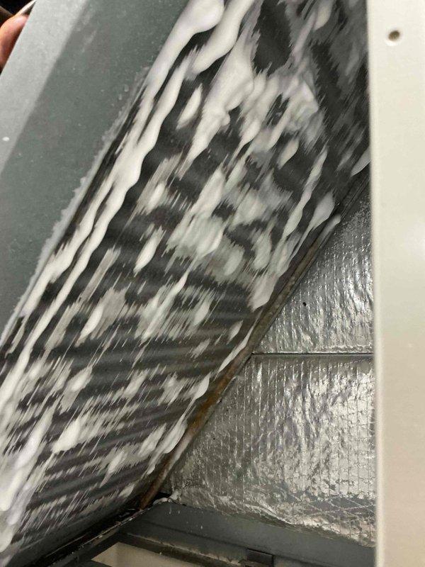 Responded to service call for air handler experiencing water leakage due to condensation buildup. Inspected unit and ductwork, documented conditions with photos showing interior duct components and air handler access panel. Identified source of moisture accumulation and addressed drainage issue to prevent further leaking.