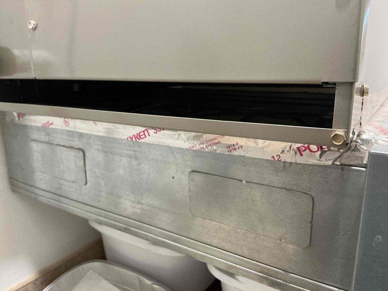 Responded to service call for air handler experiencing water leakage due to condensation buildup. Inspected unit and ductwork, documented conditions with photos showing interior duct components and air handler access panel. Identified source of moisture accumulation and addressed drainage issue to prevent further leaking.