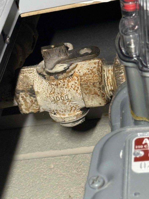Responded to emergency gas leak at commercial facility where utility company had shut off gas service due to active leak from furnace pilot light assembly. Upon arrival, accessed unit using master key and conducted safety inspection, documenting severely corroded gas valve and pilot assembly with extensive rust deterioration compromising system integrity. Recommended immediate replacement of corroded gas valve components and complete pilot light system overhaul to restore safe operation before gas service resumption.