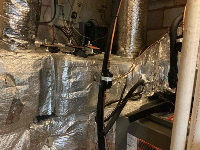 Completed follow-up service call to address multiple outstanding items from previous installation. Replaced temporary contactor on condensate pump wet switch with proper relay wired normally closed for correct operation. Tested all heating and cooling zones on second and third floors to verify proper system function across all areas. Completed humidifier wiring and relocated humidifier drain line away from furnace vent and neutralizer to proper drainage location. Reinstalled and secured insulation on upper coil plenum for proper thermal efficiency. Verified and confirmed refrigerant charge is within manufacturer specifications. Replaced thermostat batteries, which appear to have been intended for two outdoor temperature sensors that are currently missing, likely removed during condenser replacement. Outdoor sensors still require installation to complete system setup.