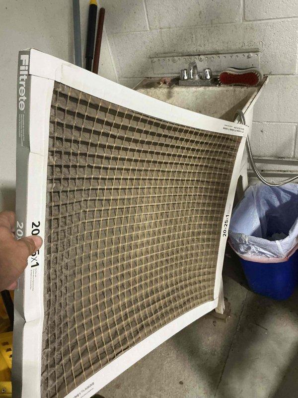 Responded to water leak complaint on HVAC system. Upon inspection, found heavily clogged air filter restricting airflow, which can cause condensate drain issues and water leakage from the unit. Removed and documented the dirty 20x20 filter showing significant dust and debris accumulation. Inspected ductwork and condensate drain line in attic space, verifying PVC drain line connections and system components. Contacted office to coordinate billing approval process with property management for condo unit as per standard procedure.