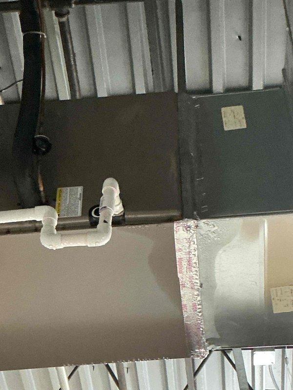 Responded to water leak complaint on HVAC system. Upon inspection, found heavily clogged air filter restricting airflow, which can cause condensate drain issues and water leakage from the unit. Removed and documented the dirty 20x20 filter showing significant dust and debris accumulation. Inspected ductwork and condensate drain line in attic space, verifying PVC drain line connections and system components. Contacted office to coordinate billing approval process with property management for condo unit as per standard procedure.