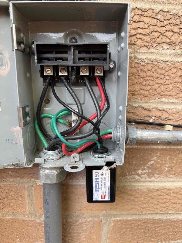 Performed comprehensive HVAC service including boiler clean and check, air handler maintenance, and air conditioning system evaluation under new Silver Comfort Plan agreement. Replaced two surge protectors on the electrical disconnect box serving the HVAC system, with units installed to protect equipment from voltage spikes. Addressed refrigerant leak in AC system by adding Easy Seal leak sealant and charging system with refrigerant under warranty coverage. Utilized UV light leak detection method to locate refrigerant leak point for proper diagnosis. System purging service for boiler hydronic system was offered as optional additional maintenance to remove air from heating loops if needed during future service visits. All electrical connections were inspected and secured during surge protector replacement, ensuring proper grounding and wire routing through exterior disconnect enclosure. AC system pressures and temperatures verified after refrigerant service to confirm proper operation a