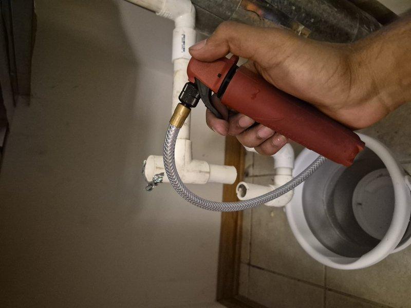 Responded to water leak originating from PVC piping connected to the air handler. Upon arrival, unit was shut off and bucket was in place collecting slow but steady water discharge. Inspected condensate drain system and identified failed or disconnected drain line connection. Removed deteriorated flexible connector and replaced with new properly-sized component. Verified all PVC connections were secure and properly sealed. Tested system operation and confirmed condensate is draining properly with no leaks present.