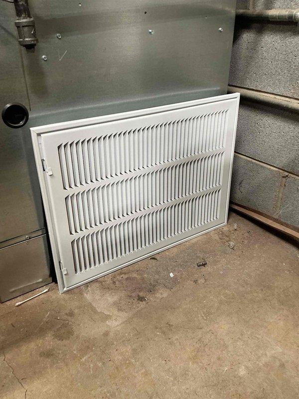 Completed commercial HVAC maintenance visit to address air return system deficiencies. Installed new 14x20x1 filter and replacement white metal return air grille with horizontal slat design, ordered from supplier as specified. Performed sheet metal work to properly integrate grille with existing rectangular galvanized ductwork mounted on concrete block wall in basement mechanical room, ensuring secure attachment and proper air flow functionality.