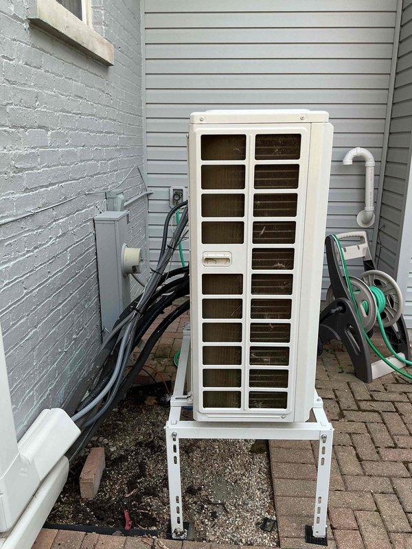 Responded to service call for two-unit HVAC system with reported water leak on one unit and cooling failure with intermittent shutdown on the second unit. Inspected exterior-mounted Bosch heat pump unit positioned on metal bracket stand in side yard area. Evaluated condensate drainage system, refrigerant lines, and electrical connections on the affected unit. Assessed operational status of both systems, documented equipment information, and photographed installation for service records.
