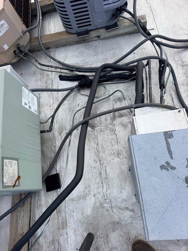Responded to service call regarding missing refrigerant line insulation on roof-mounted AC condensing units. Conducted visual inspection of multiple rooftop units and confirmed that thermal insulation had been removed from refrigeration lines on numerous condensers. Documented existing conditions through photography, capturing current state of units, electrical connections, mounting platforms, and exposed refrigerant lines. Provided assessment that missing insulation compromises system efficiency, allows heat gain affecting cooling capacity, and may impact compressor longevity. Quoted material and labor for insulation replacement work to restore proper thermal protection to refrigerant lines.