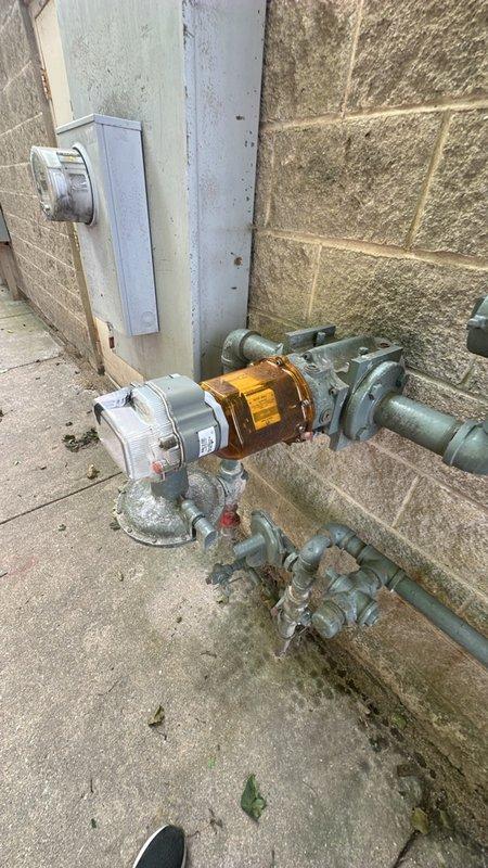 Conducted site visit at commercial laundry facility to assess requirements for installation of tankless water heater system, specifically CXC 199 IN model. Measured clearances in mechanical space and documented existing gas meter infrastructure and utility connections to determine feasibility and specifications for commercial tankless water heater installation.