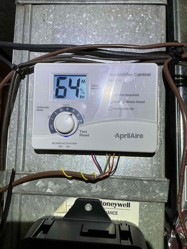 Completed annual Comfort Plan clean and check on furnace and water heater system. Performed comprehensive inspection and maintenance procedures per agreement guidelines, verified AprilAire humidifier operation showing 84% RH on digital display with system functioning in automatic mode, confirmed proper humidifier control settings and blower activation, documented temperature readings of 119.9°F indicating normal system operation, inspected all electrical connections and wiring, and collected payment for Comfort Plan renewal.