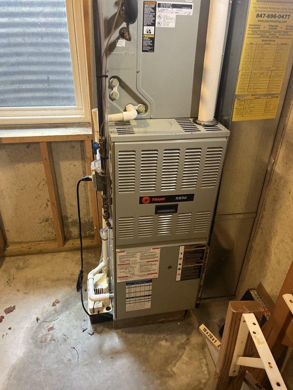 Conducted comprehensive estimate for replacement of 26-year-old residential air conditioning system. Customer expressed dissatisfaction with current HVAC service provider and requested evaluation of aging equipment. Primary AC unit has reached end of serviceable life at 26 years, while secondary unit at approximately 20 years continues to operate satisfactorily. Documented existing Trane XE80 furnace installation and current air handler configuration in basement mechanical space. Photographed equipment layout, refrigerant line routing, electrical connections, and overall system condition to provide accurate replacement specifications and ensure proper sizing for new equipment installation.