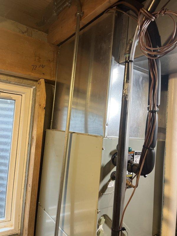 Conducted comprehensive estimate for replacement of 26-year-old residential air conditioning system. Customer expressed dissatisfaction with current HVAC service provider and requested evaluation of aging equipment. Primary AC unit has reached end of serviceable life at 26 years, while secondary unit at approximately 20 years continues to operate satisfactorily. Documented existing Trane XE80 furnace installation and current air handler configuration in basement mechanical space. Photographed equipment layout, refrigerant line routing, electrical connections, and overall system condition to provide accurate replacement specifications and ensure proper sizing for new equipment installation.
