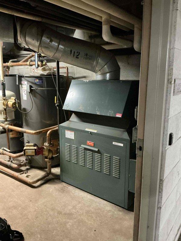 Responded to no-heat call at commercial building following power outage. Upon arrival, found hot water boiler system non-operational after power restoration. Inspected burner assembly, gas valves, and ignition controls; verified gas supply and electrical connections were intact. Reset boiler control system, checked flame sensor operation, and successfully relit burners with proper blue flame combustion visible. Confirmed system returned to normal operation with hot water circulation restored to building.