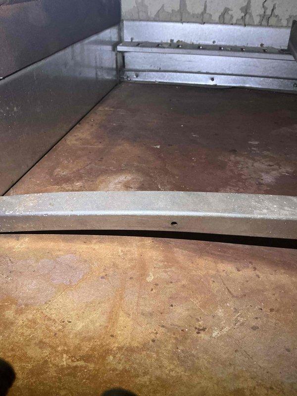 Completed fall preventive maintenance inspection on commercial HVAC system per maintenance agreement. Performed comprehensive cleaning and operational checks on all equipment including three Burnham boilers (units left offline per facility directive), two B&G circulation pumps, two tankless water heaters, two Greenheck exhaust fans, and two York rooftop units. Inspected burner assemblies, gas valve components, and ignition systems on boiler #2, noting surface oxidation on metal components consistent with normal aging. Examined drip pan conditions on rooftop equipment, observing mineral deposits and surface rust staining from condensate exposure. All circulating pumps, exhaust fans, and RTUs tested and found operational. System components documented photographically for maintenance records.