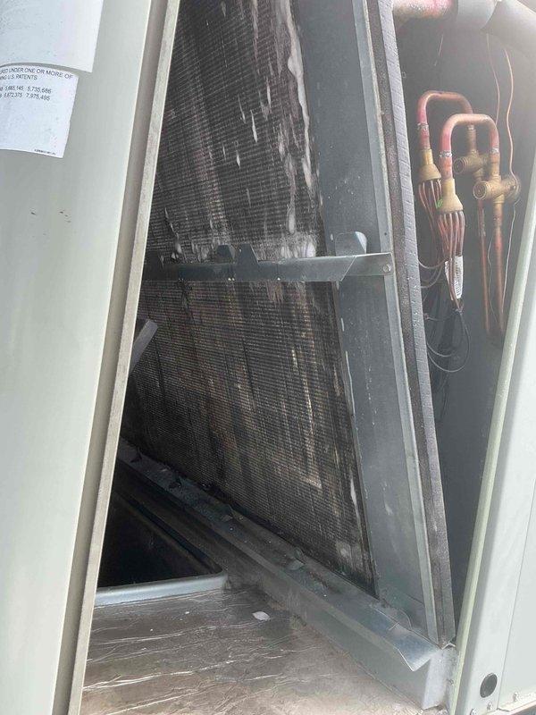 Performed evaporator coil cleaning service on rooftop units 3, 4, and 5. Accessed interior of each RTU, applied specialized coil cleaner to remove accumulated dust, debris, and discoloration from evaporator coil surfaces and fins. Documented pre-cleaning condition showing significant buildup on coil mesh and drain pan areas, then completed thorough cleaning to restore proper airflow and heat transfer efficiency across all three units.